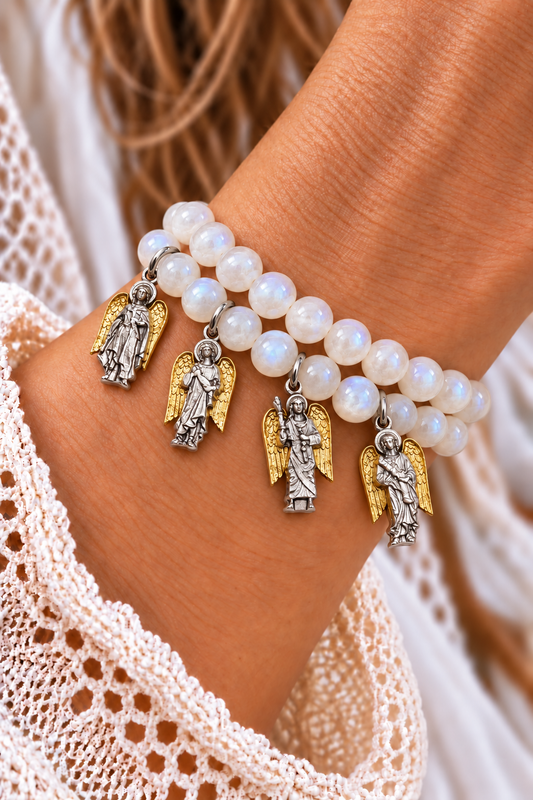 Two white moonstone bracelets with four silver-tone archangel charms and gold-tone wings worn on a wrist | Bliss by Cori