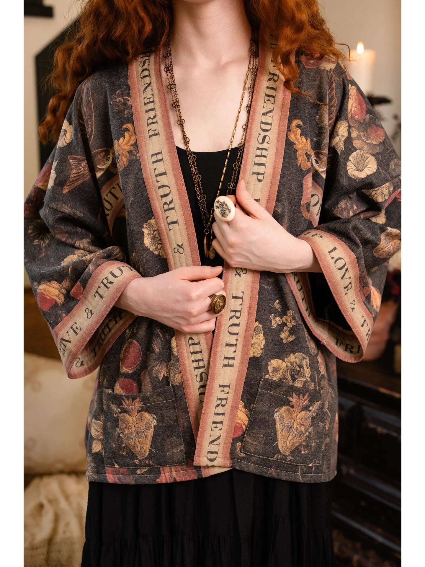 Heart of Gold Cottage Jacket worn open over black dress in candlelit setting | Bliss by Cori