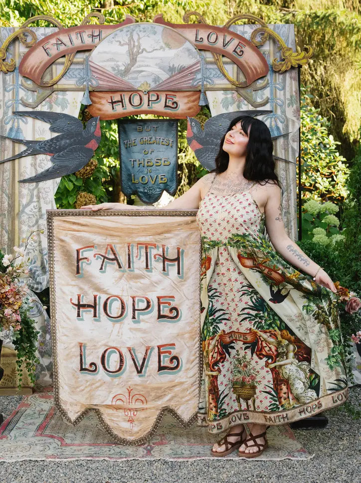 Faith Hope Love banner: Model wearing the floral-bodice side of the Book of Love maxi dress beside a Faith Hope Love banner | Bliss by Cori