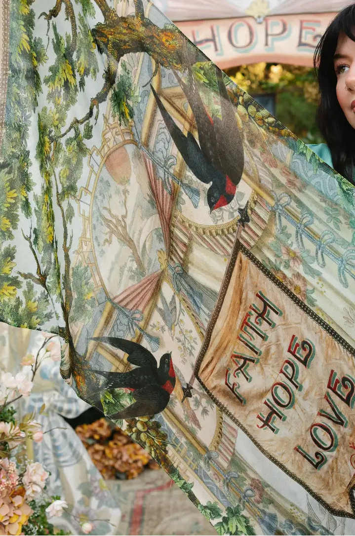 Book of Love scarf close-up showing black swallows, green foliage, vintage drapery, and Faith Hope Love banner | Bliss by Cori