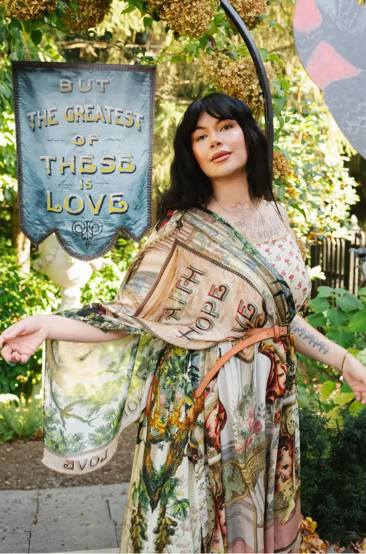 Book of Love scarf worn as a belted shoulder wrap, showing its Faith Hope Love banner and airy printed fabric | Bliss by Cori