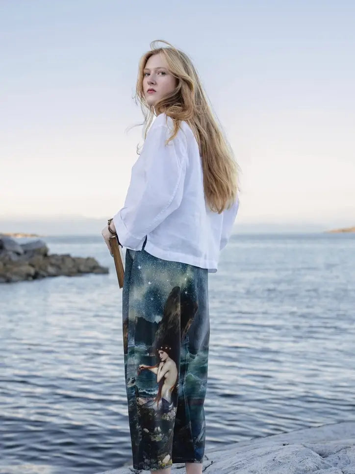 Side view of the Siren celestial print pants styled with a flowing white top | Bliss by Cori