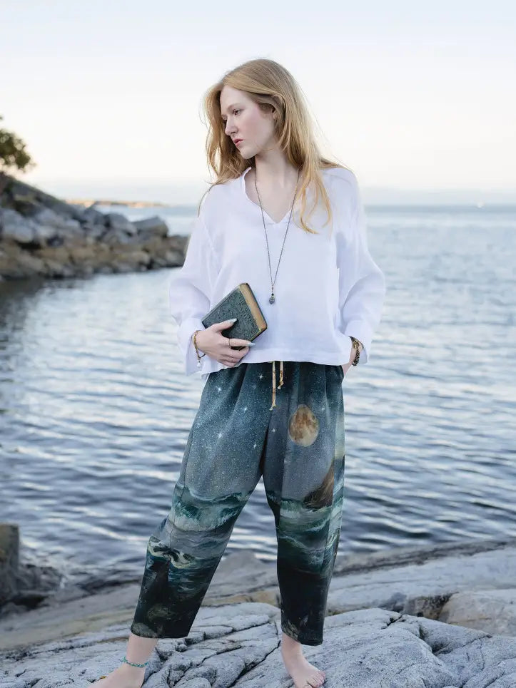 Model wearing the Siren mermaid Artist Pants with a white top beside the water | Bliss by Cori