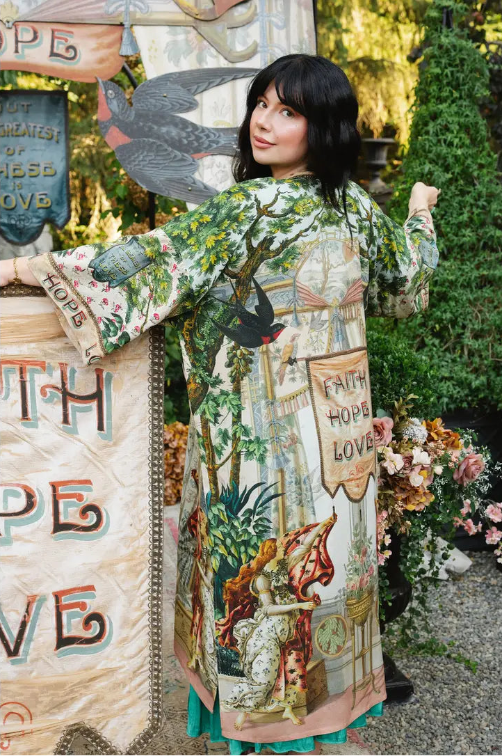 Model looking over her shoulder in Book of Love duster, showing swallow artwork and printed back panel | Bliss by Cori