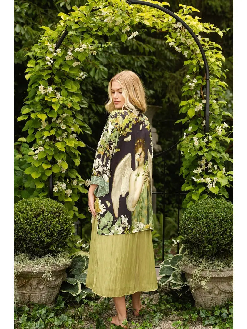Side view of the Equinox duster featuring Pandora artwork framed by lush garden greenery | Bliss by Cori