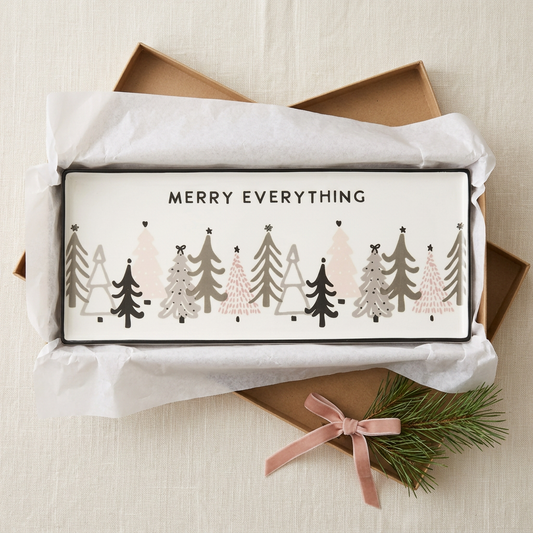 Merry Everything ceramic Christmas tree tray nestled in tissue in a kraft box beside pine tied with blush ribbon | Bliss by Cori